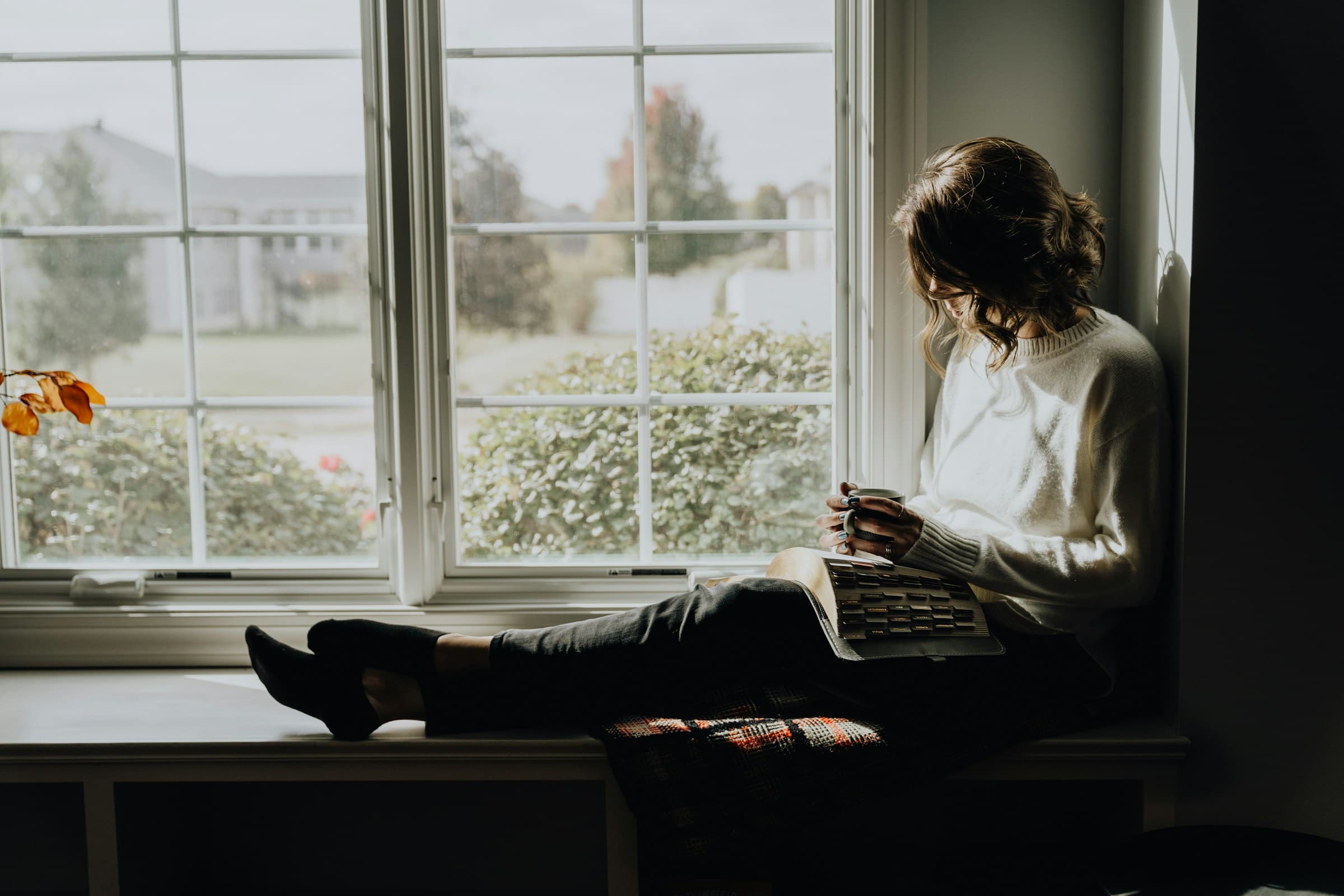 Reading notes on a window sill in morning light